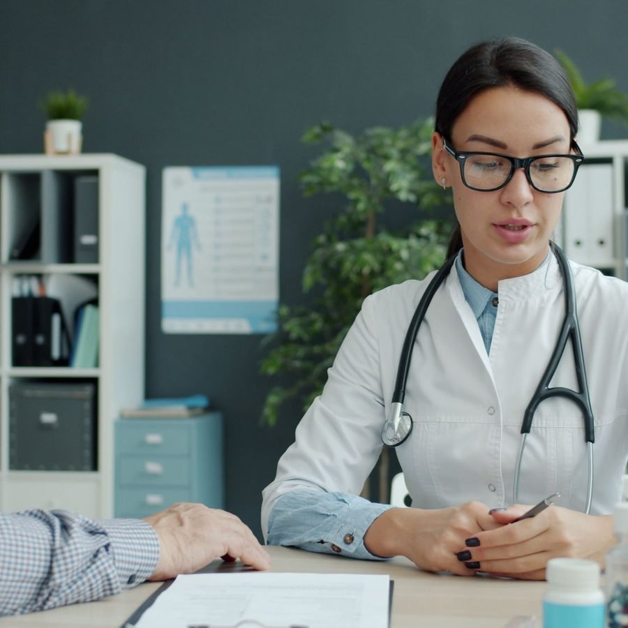 Doctor speaking with a senior patient in a bright office